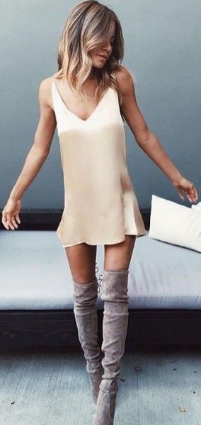 blush pink mini slip dress with gray suede high boots