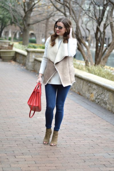 gray vest with white tee and blue skinny jeans