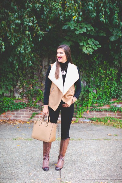 camel and white shearling vest with black skinny jeans and knee-high boots