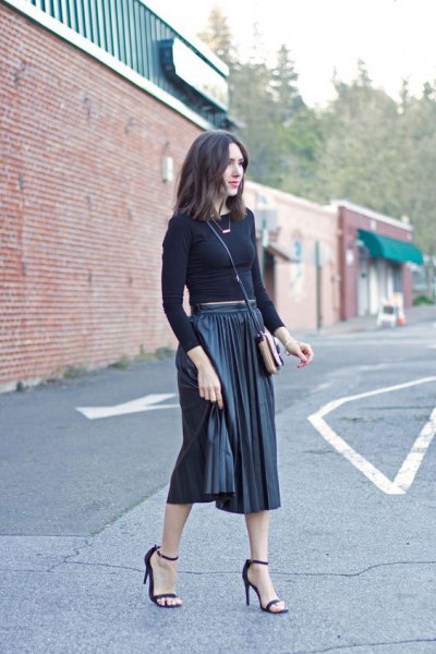 form-fitting cropped sweater with black midi-pleated skirt