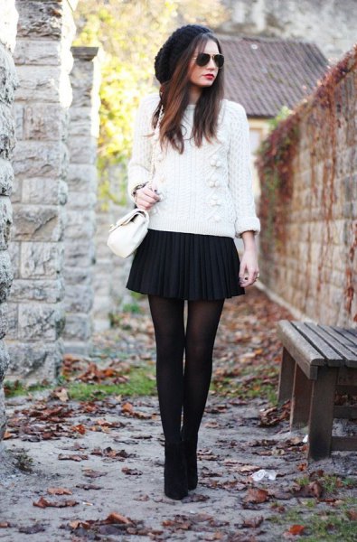 white knitted sweater with black mini pleated skirt