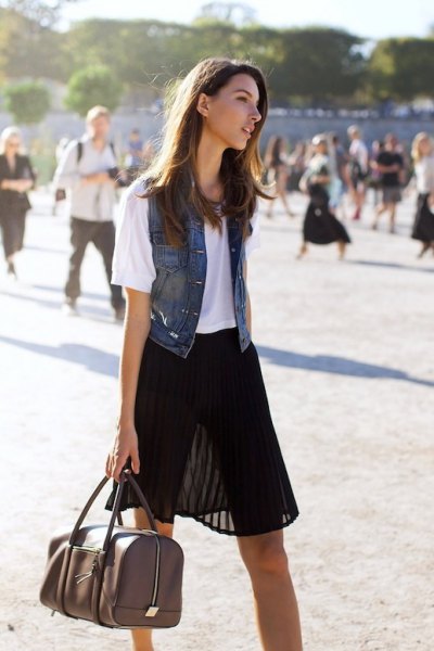 black semi-colored mini pleated skirt with white tee and denim vest