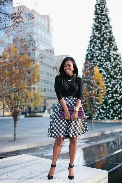 black half-warm knitted sweater with plaid midi-flared skirt