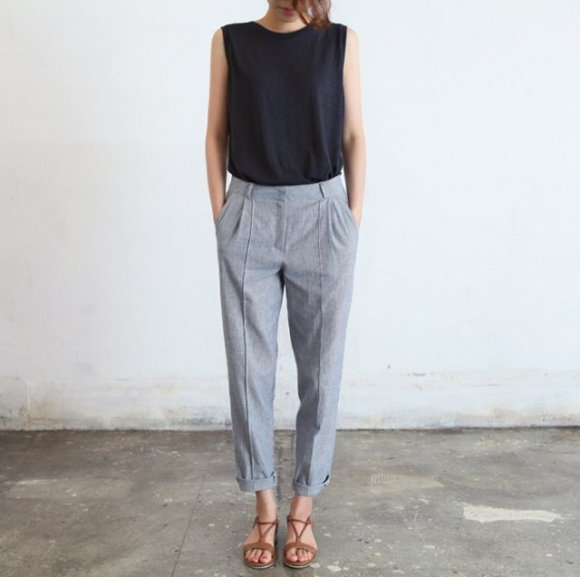 black sleeveless top with gray ankle trousers