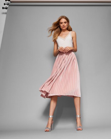 white camisole with light pink pleated midi skirt