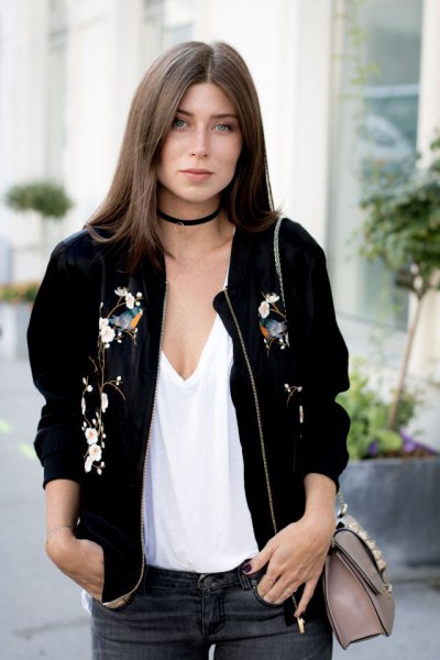 bomber jacket with low cut white vest and black choker