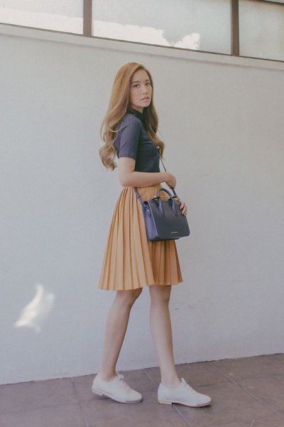 gray short sleeve top with mock neck with orange pleated skater mini skirt