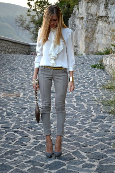 white ruffled blouse with gray skinny cropped dress pants