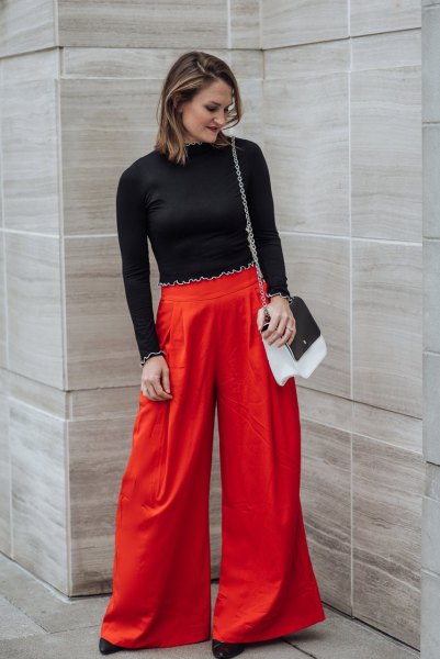 black cropped sweater with red wide leg trousers