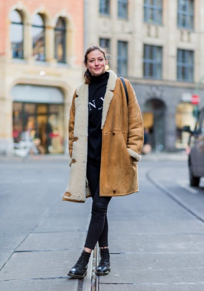 brown long shearling skirt with black sweater and cropped jeans
