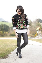 black embroidered sweater with white leather leather buttons