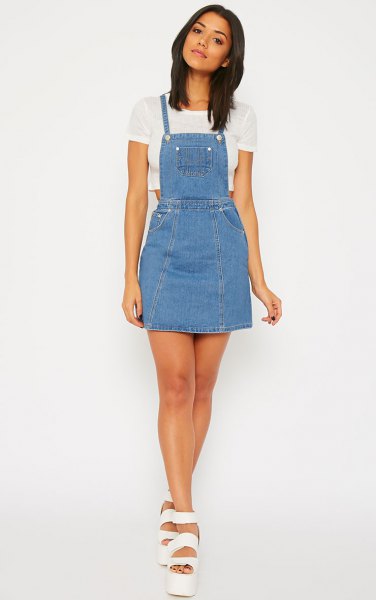 white cropped t-shirt with light blue denim pinafore dress
