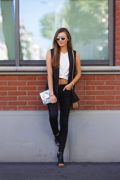 white cropped sleeveless top and black skinny jeans