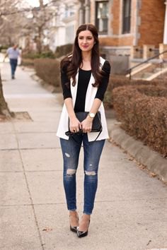 white sleeveless blazer with black half-heated tee and ripped jeans