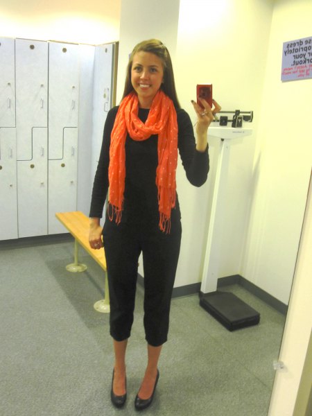 black knit sweater with capris and orange scarf