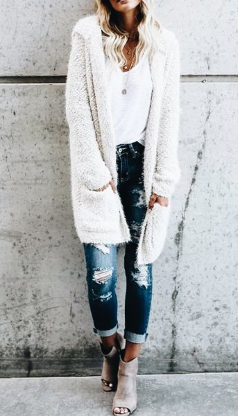 white fuzzy long hooded cardigan with ripped skinny jeans