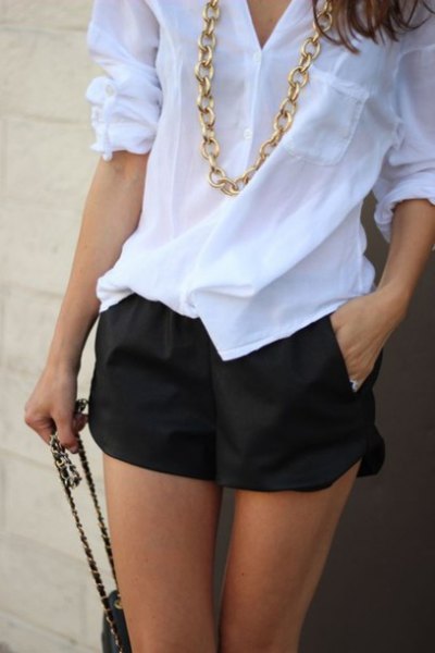 white linen shirt with black floating shorts gold necklace