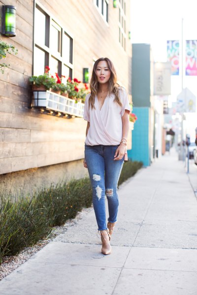 pale pink chiffon wrap blouse with ripped skinny jeans