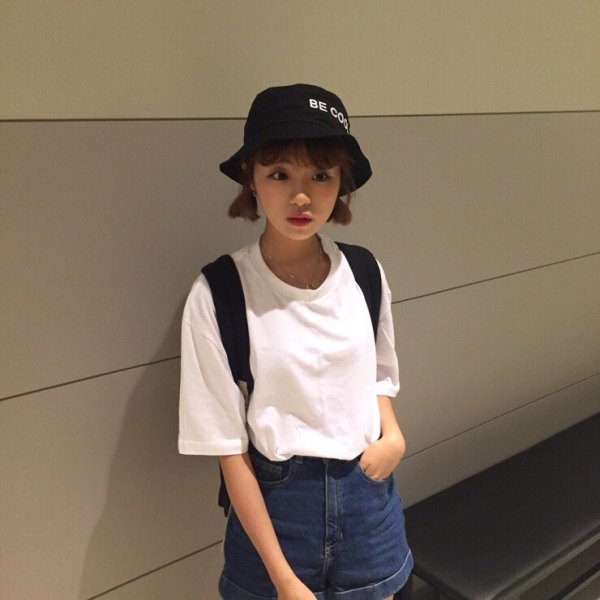 black bucket hat with white big tee and flowing shorts with denim