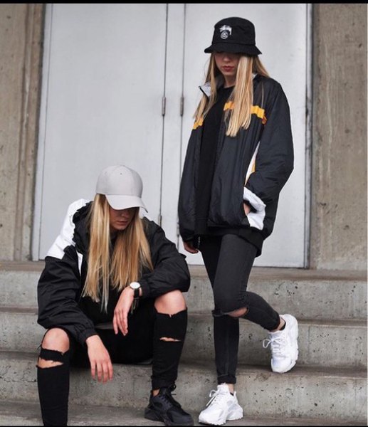 black bucket hat with windbreaker and ripped jeans