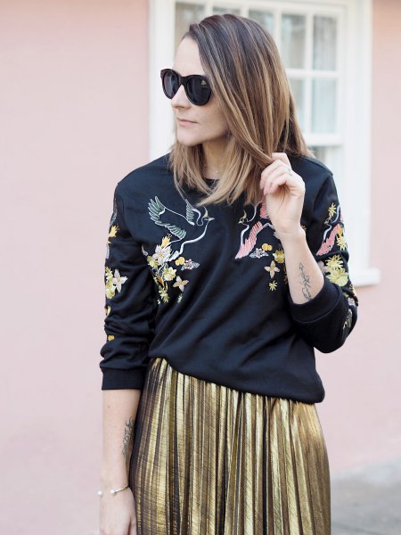 black sweater with gold pleated midi skirt