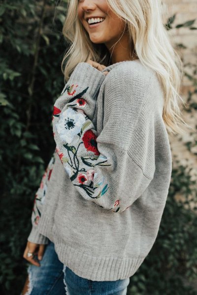 light gray embroidered chunky sweater with skinny jeans