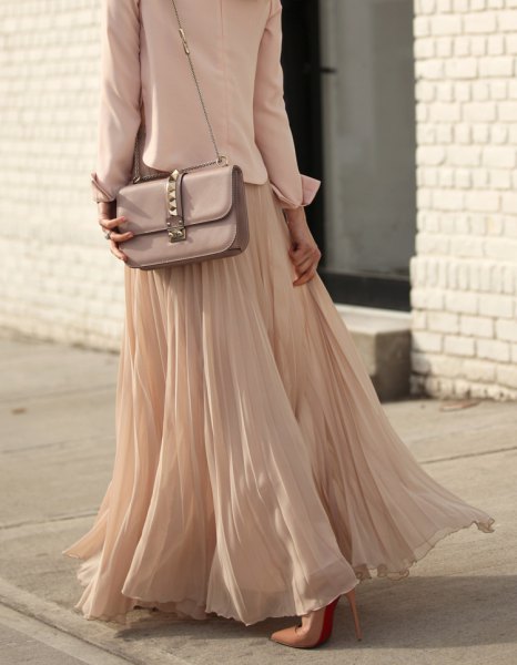 pink and silver shoulder bag with reddish maxi skirt