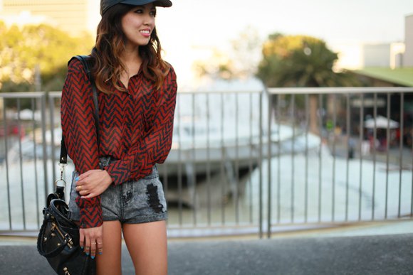 baseball cap with red and black patterned shirt gray denim shorts