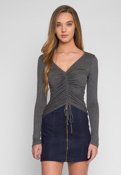 gray v-neck ruched long sleeve top dark blue mini skirt