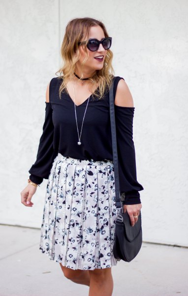 black v-top with white floral pleated knee length skirt