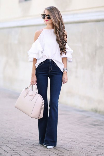 white halter neck cold shoulder sweater with puffed jeans