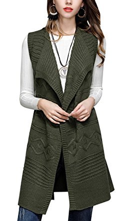 green long cable knit sweater vest over white ribbed top