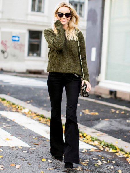 green rib knit sweater with black flared trousers