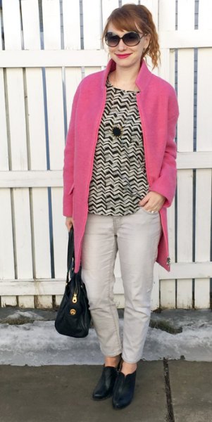 neon pink coat black and white patterned sweater