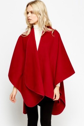 red fleece poncho with white sweater with hollow neck