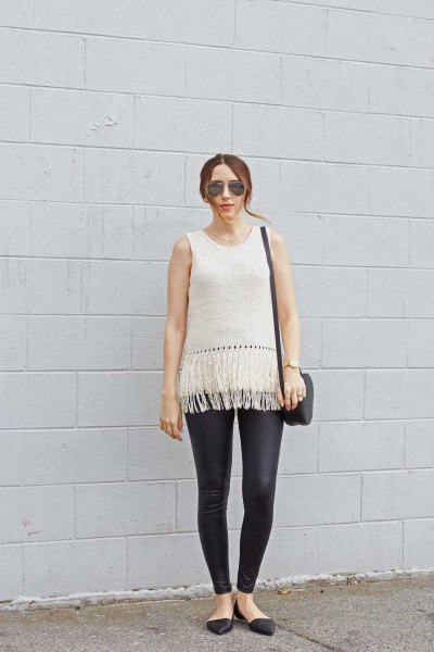 white sleeveless knitted sweaters in black leather leggings