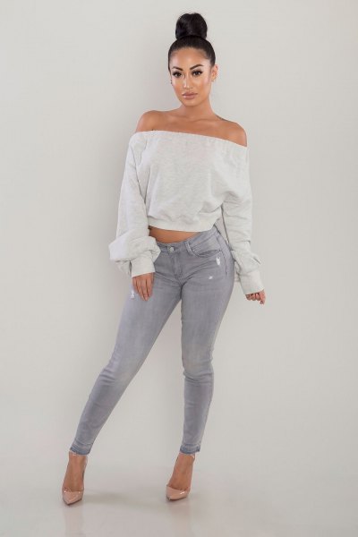 white off the shoulder cropped sweater gray skinny jeans