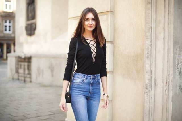 black lace up top blue washed skinny jeans