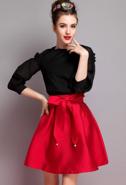 black knitted sweater red knotted flare skirt