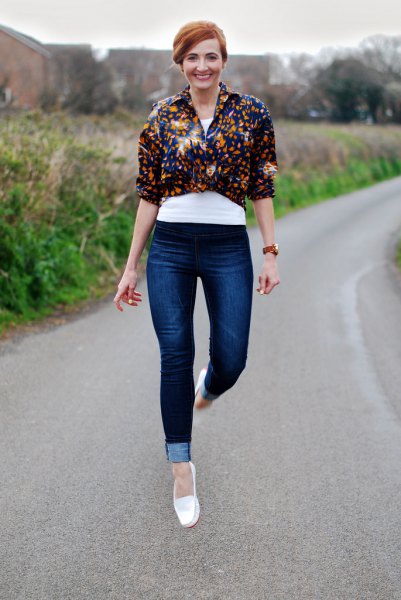 white loafers black floral knotted shirt