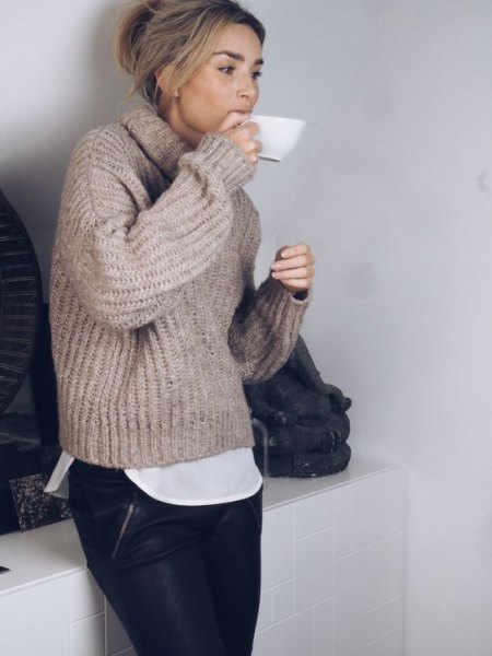 gray chunky sweater with high neck and leather pants