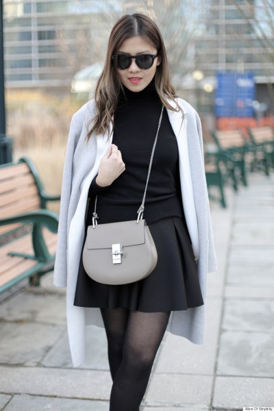 gray wool coat over shoulder black skater skirt