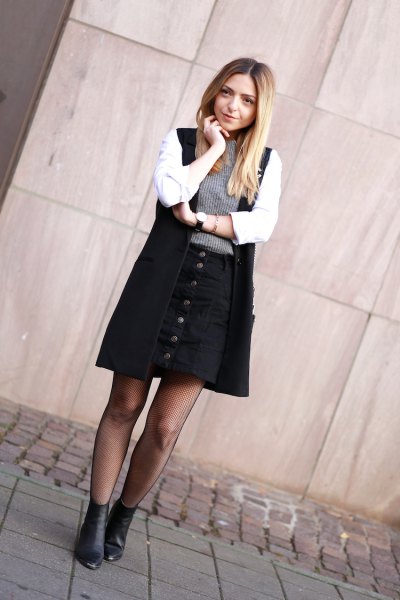 white shirt black long vest and button up skirt