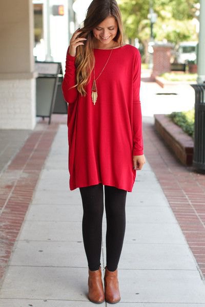 red tunic top with black leggings and boots