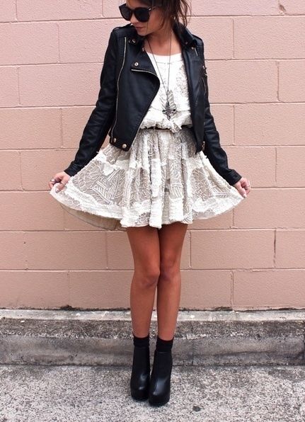white lacey short dress, black leather jacket, black sunglasses .
