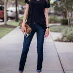 black t-shirt, blue jeans, black heels, leopard print purse .