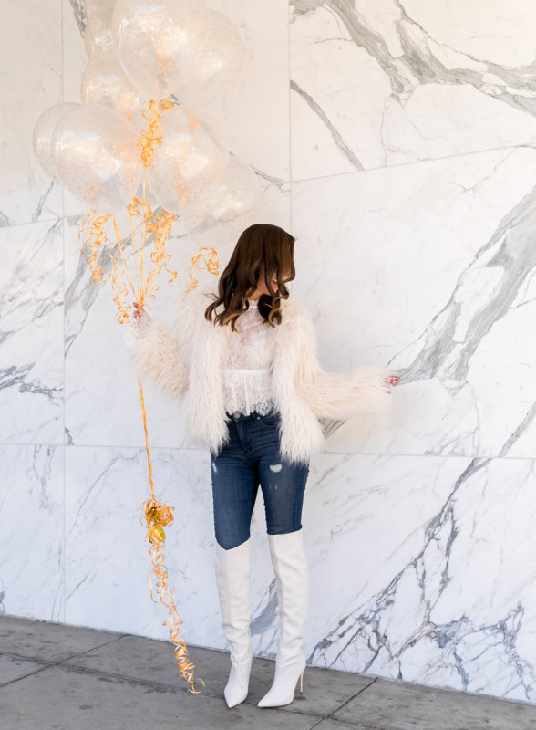 Sydne Style wears bcbg white lace top with faux fur jacket for .
