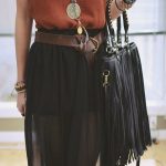 Loose tank top, leather fringe purse and black layered skirt with .