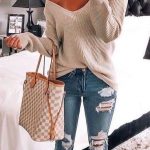 Cute off the shoulder knit sweater with trendy distressed denim .