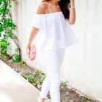 Picture Of white jeans, an off the shoulder top, a pink clutch and .